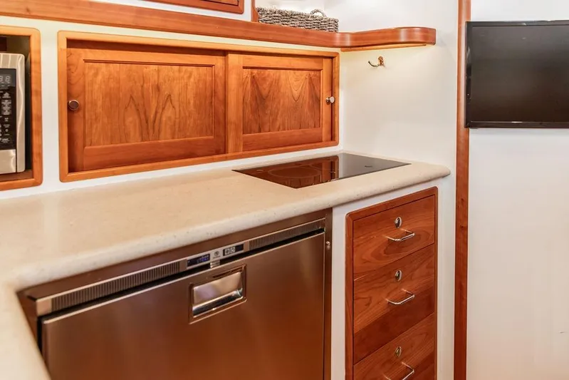 Goombay Yacht Photos Pics Luxurious 2018 MJM 43z yacht kitchen with wooden cabinets and modern appliances.