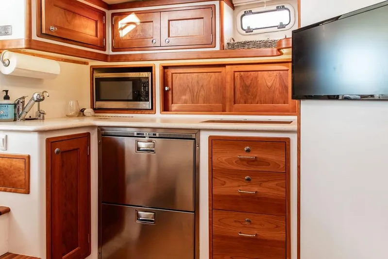 Goombay Yacht Photos Pics Luxurious 2018 MJM 43z yacht kitchen with wood cabinetry and modern appliances.