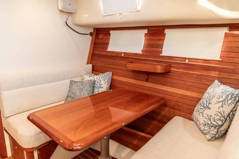 Goombay Yacht Photos Pics Interior of 2018 MJM 43z yacht with wooden table and cushioned seating.