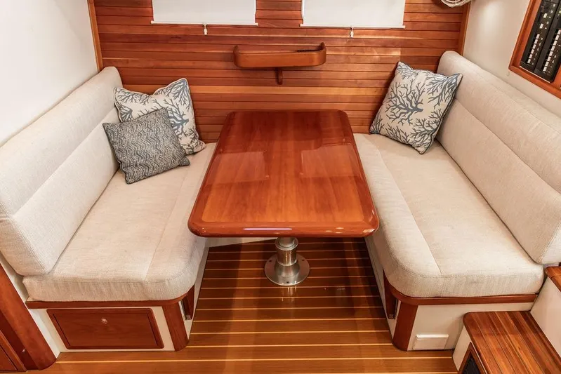 Goombay Yacht Photos Pics Luxurious 2018 MJM 43z yacht interior with elegant wood table and cushioned seating.