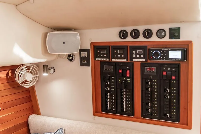 Goombay Yacht Photos Pics Control panel inside 2018 MJM 43z boat, featuring switches, gauges, and speaker.