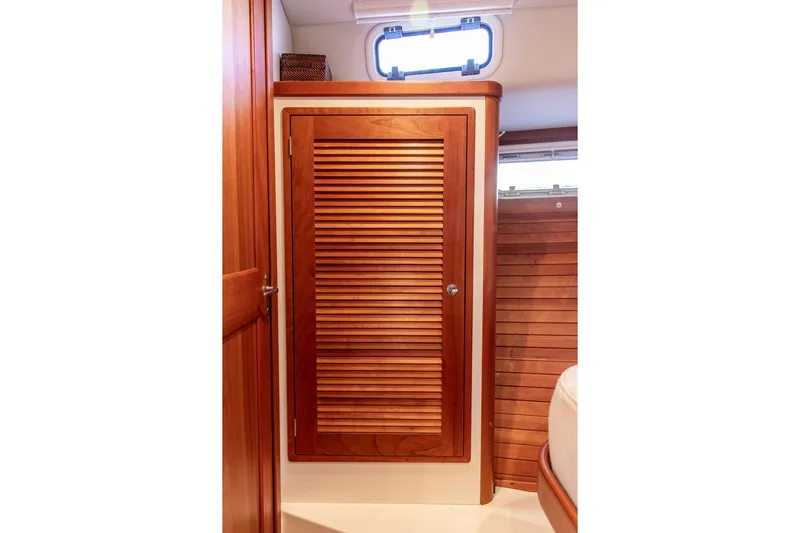 Goombay Yacht Photos Pics Wooden interior of 2018 MJM 43z boat, featuring a louvered cabinet door.