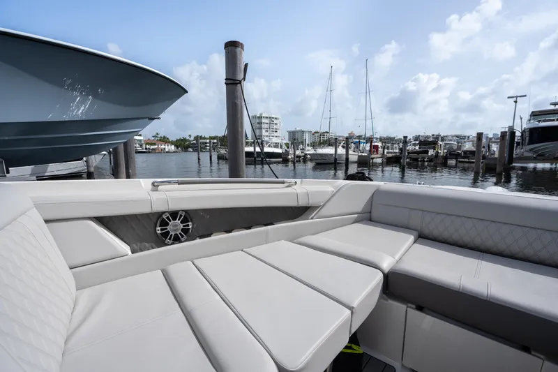  Yacht Photos Pics 2023 Sea Ray 350 Sundancer interior with luxurious seating at a marina.