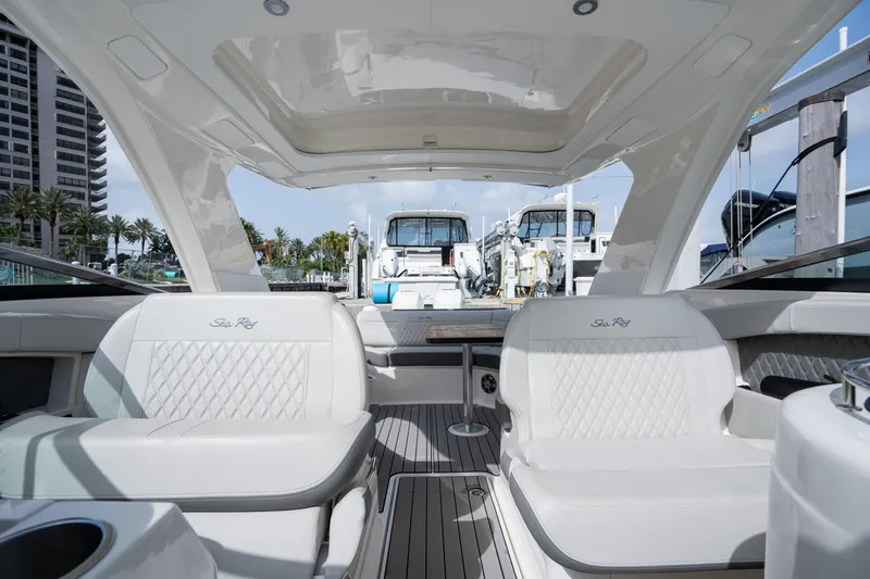  Yacht Photos Pics Luxurious interior of 2023 Sea Ray 350 Sundancer yacht at marina, featuring elegant seating.