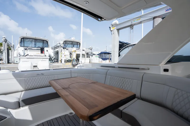  Yacht Photos Pics 2023 Sea Ray 350 Sundancer yacht interior with elegant seating and wooden table.