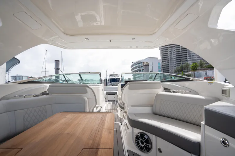  Yacht Photos Pics 2023 Sea Ray 350 Sundancer interior with luxurious seating and wooden table.