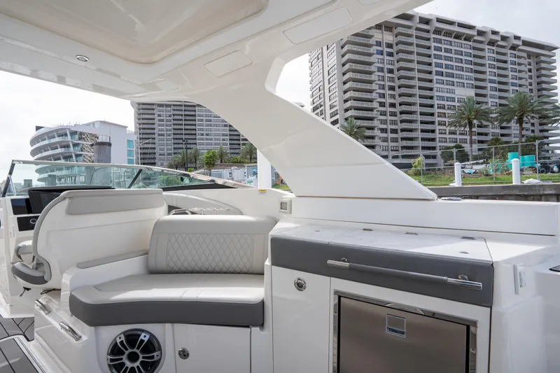  Yacht Photos Pics 2023 Sea Ray 350 Sundancer yacht interior with modern seating and cityscape background.