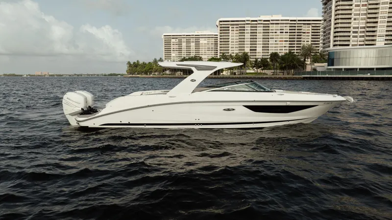 Yacht Photos Pics 2023 Sea Ray 350 Sundancer yacht on water with cityscape background.