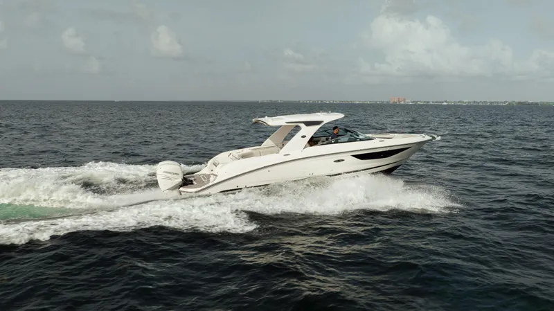  Yacht Photos Pics 2023 Sea Ray 350 Sundancer cruising on open water under a cloudy sky.