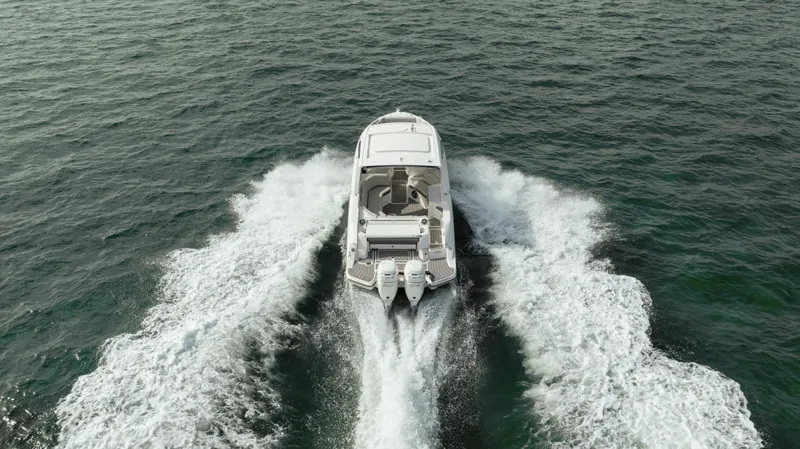 Yacht Photos Pics 2023 Sea Ray 350 Sundancer cruising on open water, creating a dynamic wake.