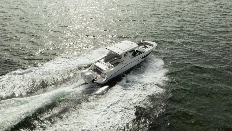  Yacht Photos Pics 2023 Sea Ray 350 Sundancer cruising on open water, creating a wake.