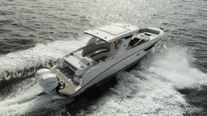  Yacht Photos Pics 2023 Sea Ray 350 Sundancer cruising on open water, showcasing sleek design and powerful engines.