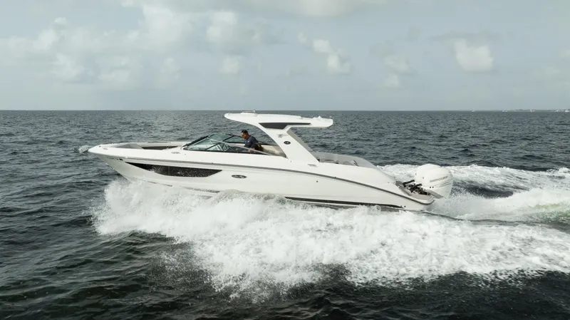  Yacht Photos Pics 2023 Sea Ray 350 Sundancer cruising on open water, showcasing sleek design and powerful performance.