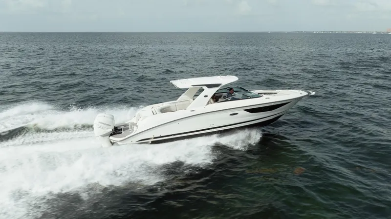  Yacht Photos Pics 2023 Sea Ray 350 Sundancer cruising on open water, showcasing sleek design and powerful performance.