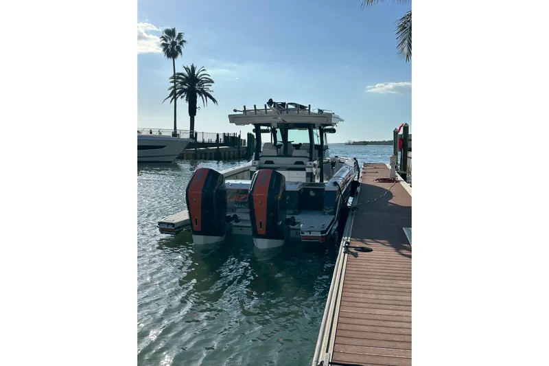  Yacht Photos Pics 2024 Formula 387 Center Console Fish boat docked by palm trees.