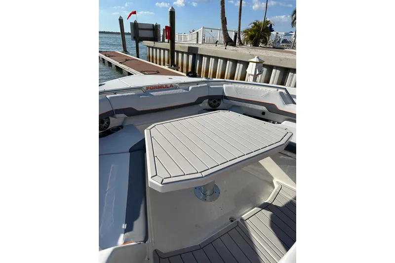 Yacht Photos Pics 2024 Formula 387 Center Console Fish boat interior with table, docked by the water.