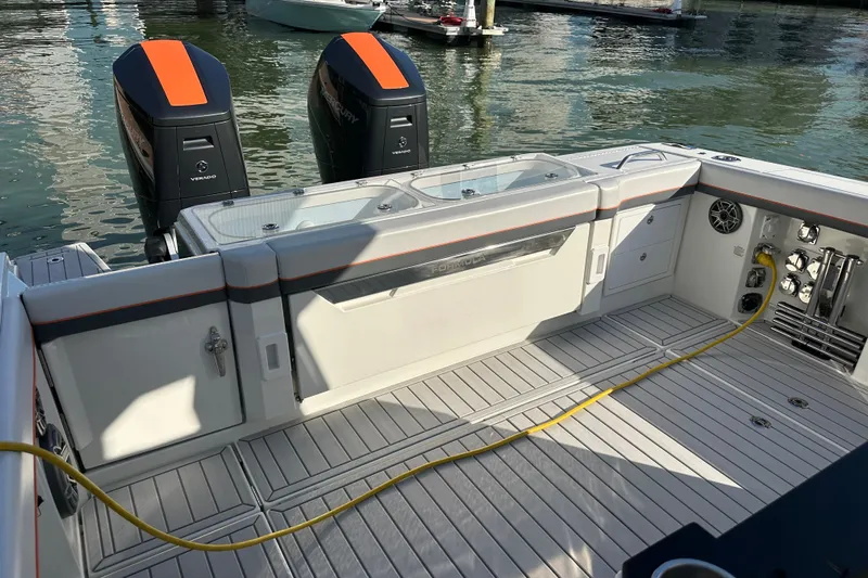  Yacht Photos Pics 2024 Formula 387 Center Console Fish boat with dual outboard engines, docked on water.