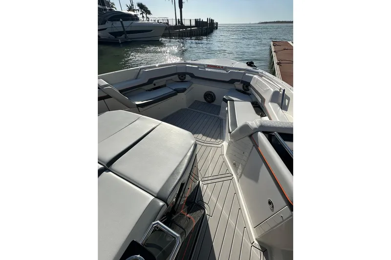  Yacht Photos Pics 2024 Formula 387 Center Console Fish boat interior with seating, docked by the water.