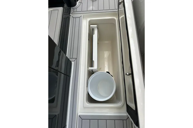  Yacht Photos Pics 2024 Formula 387 Center Console Fish storage compartment with bucket, open lid view.