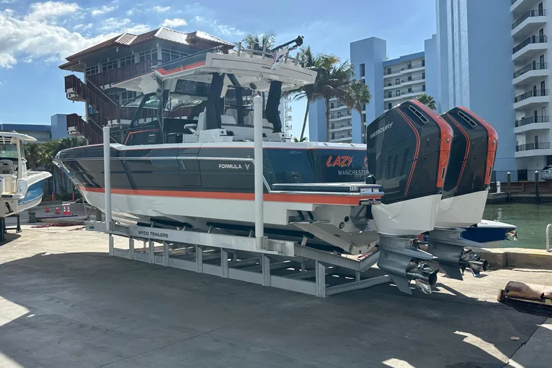  Yacht Photos Pics 2024 Formula 387 Center Console Fish boat on trailer, dockside with twin Mercury engines.