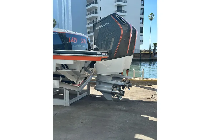  Yacht Photos Pics 2024 Formula 387 Center Console Fish boat with Mercury outboard engines docked by waterfront.