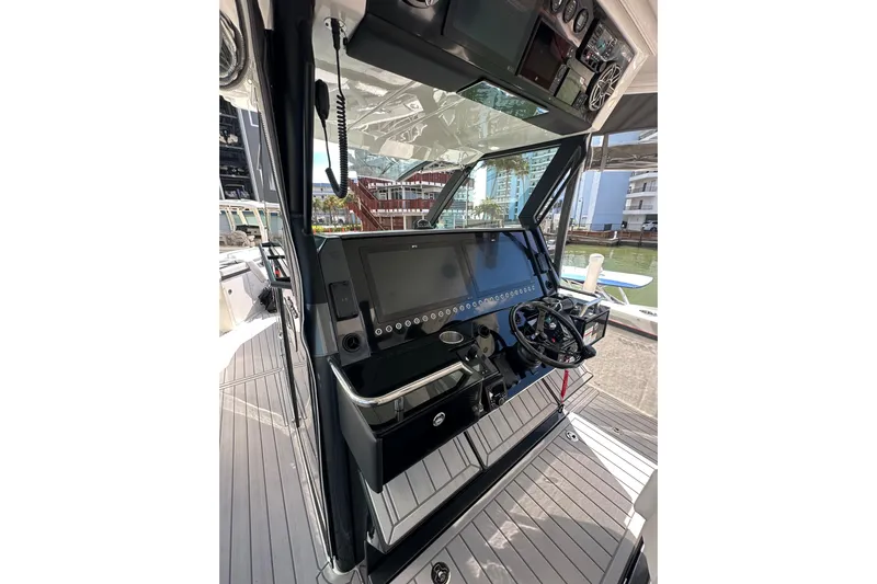  Yacht Photos Pics 2024 Formula 387 Center Console Fish boat dashboard with modern controls and steering wheel.