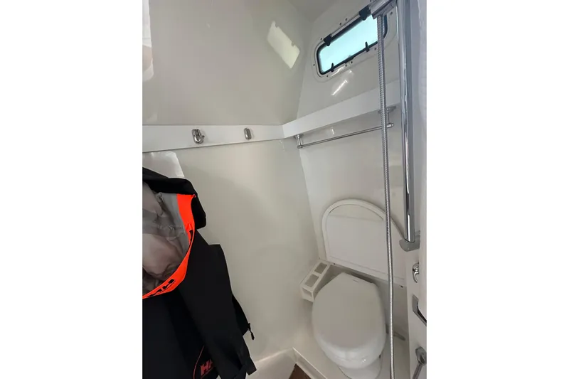  Yacht Photos Pics 2024 Formula 387 Center Console Fish boat interior bathroom with toilet and window.