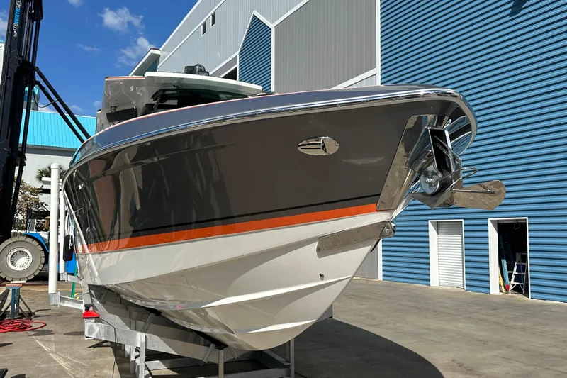  Yacht Photos Pics 2024 Formula 387 Center Console Fish boat in marina, sleek design with orange accent.