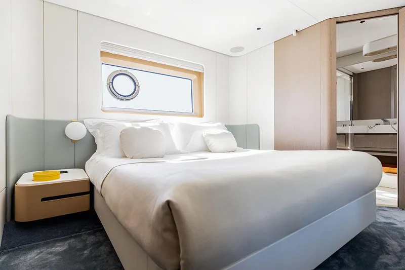  Yacht Photos Pics Luxurious bedroom interior of 2025 Azimut 26 Metri yacht, featuring modern design and elegant furnishings.