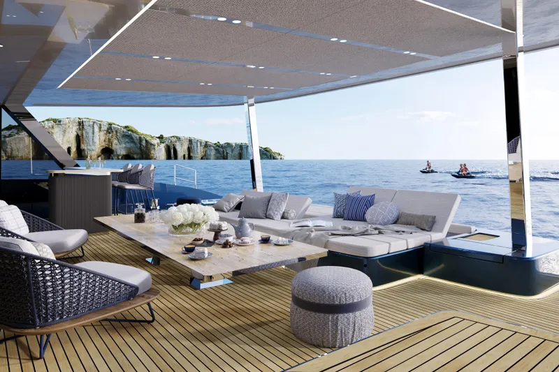  Yacht Photos Pics Luxurious Sunreef 100 yacht deck with elegant seating, ocean view, and cliffs in the background, 2026 model.