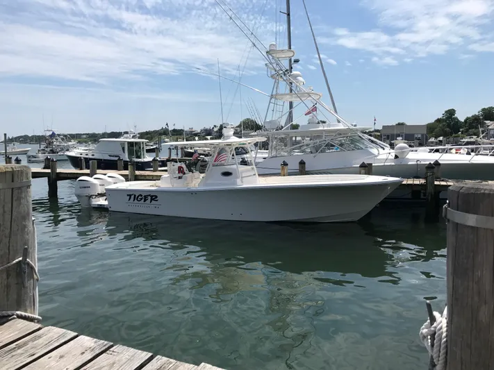 Tiger Yacht Photos Pics 2017 Regulator 34SS boat docked at a marina under a partly cloudy sky.