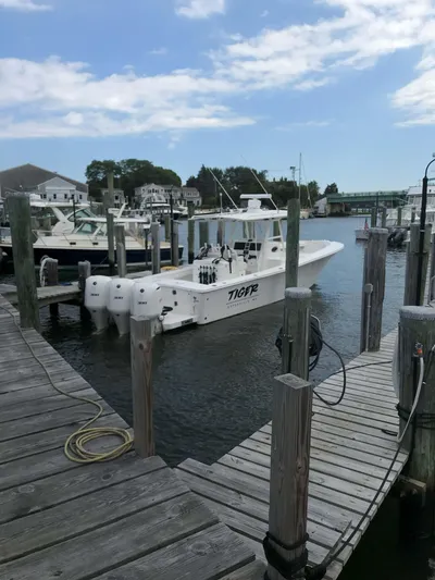 Tiger Yacht Photos Pics 2017 Regulator 34SS boat docked at a marina under a partly cloudy sky.