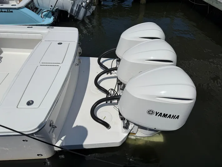Tiger Yacht Photos Pics 2017 Regulator 34SS boat with triple Yamaha outboard engines docked in water.