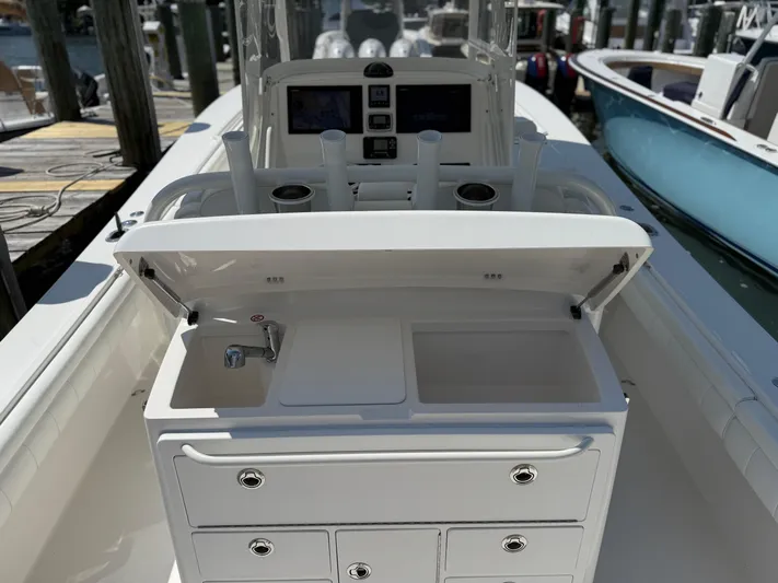 Tiger Yacht Photos Pics 2017 Regulator 34SS boat with sink, storage drawers, and rod holders at a marina.