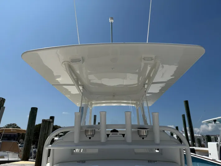 Tiger Yacht Photos Pics 2017 Regulator 34SS boat with T-top and rod holders, docked under clear blue sky.
