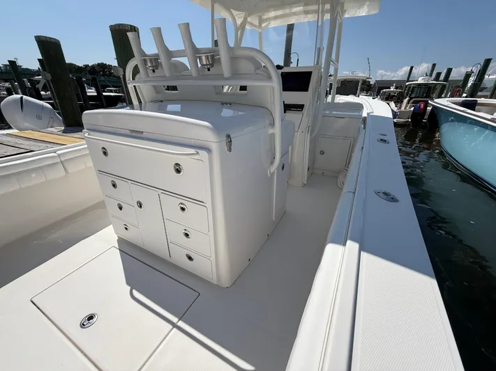 Tiger Yacht Photos Pics 2017 Regulator 34SS boat interior with storage compartments and rod holders at a marina.