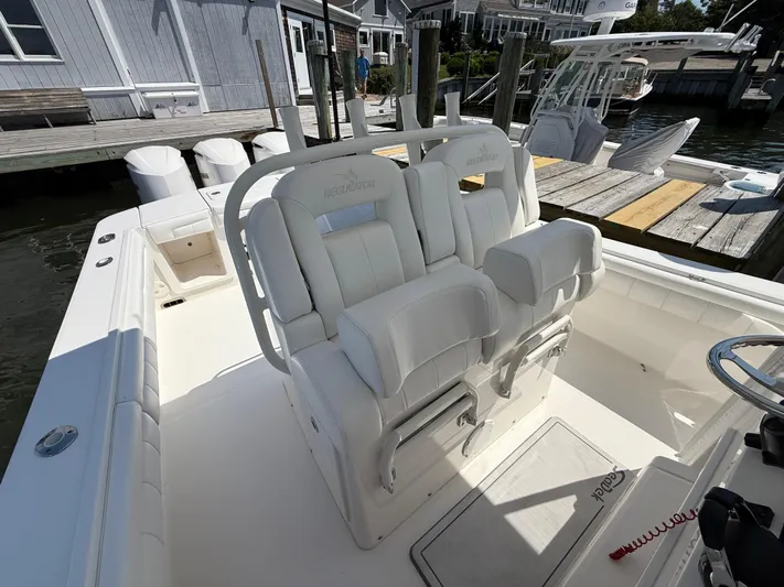 Tiger Yacht Photos Pics 2017 Regulator 34SS boat with white seating and docked at a marina.