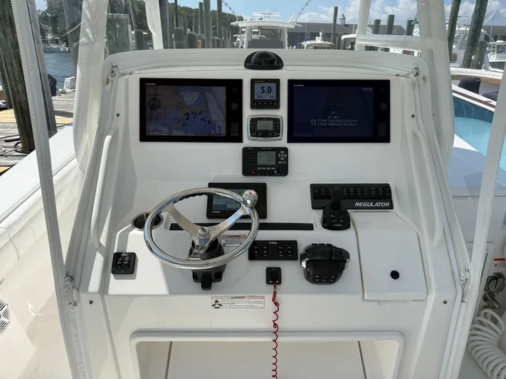 Tiger Yacht Photos Pics 2017 Regulator 34SS boat dashboard with navigation screens and steering wheel.