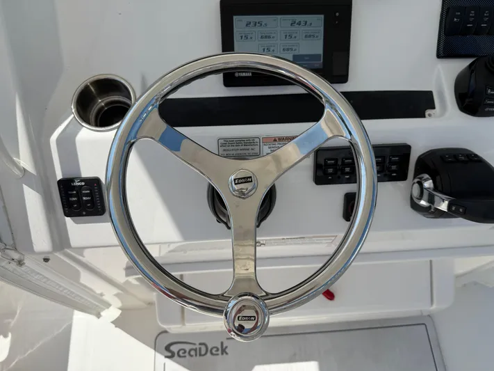 Tiger Yacht Photos Pics Steering wheel of 2017 Regulator 34SS boat with control panel and SeaDek flooring.