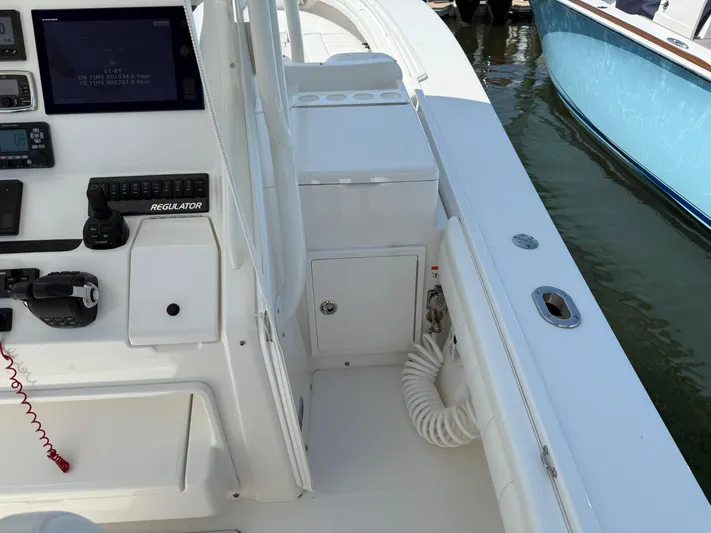 Tiger Yacht Photos Pics 2017 Regulator 34SS boat cockpit with control panel and seating area.