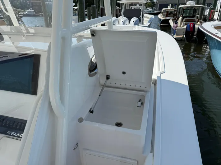 Tiger Yacht Photos Pics 2017 Regulator 34SS boat with open storage compartment at marina.