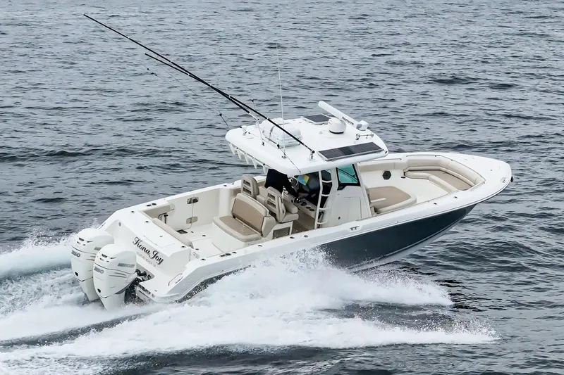  Yacht Photos Pics 2019 Boston Whaler 330 Outrage cruising on open water, showcasing sleek design and powerful engines.