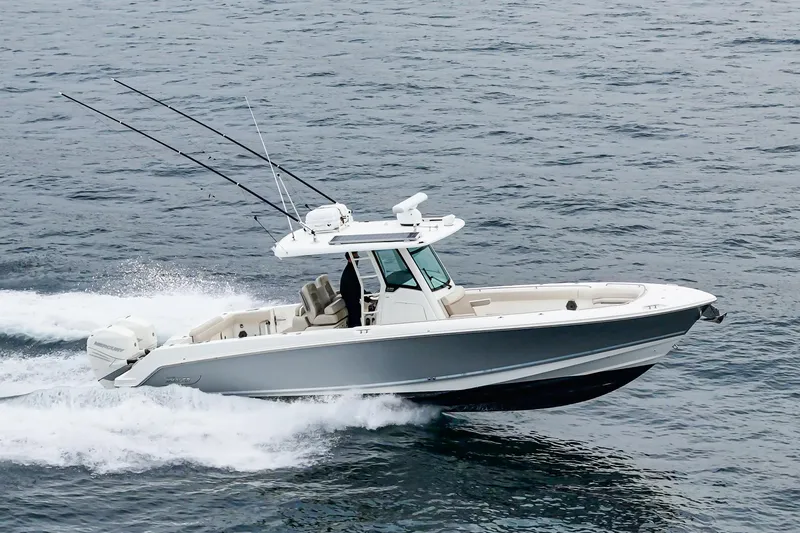  Yacht Photos Pics 2019 Boston Whaler 330 Outrage cruising on open water, showcasing sleek design and performance.