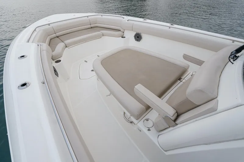  Yacht Photos Pics 2019 Boston Whaler 330 Outrage boat interior with cushioned seating and spacious deck.