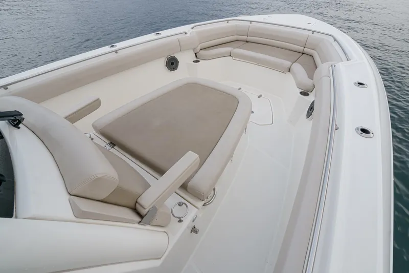  Yacht Photos Pics 2019 Boston Whaler 330 Outrage boat interior with cushioned seating and spacious deck.
