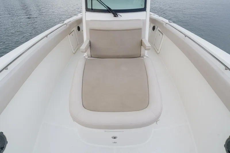  Yacht Photos Pics 2019 Boston Whaler 330 Outrage boat interior with cushioned seating area.