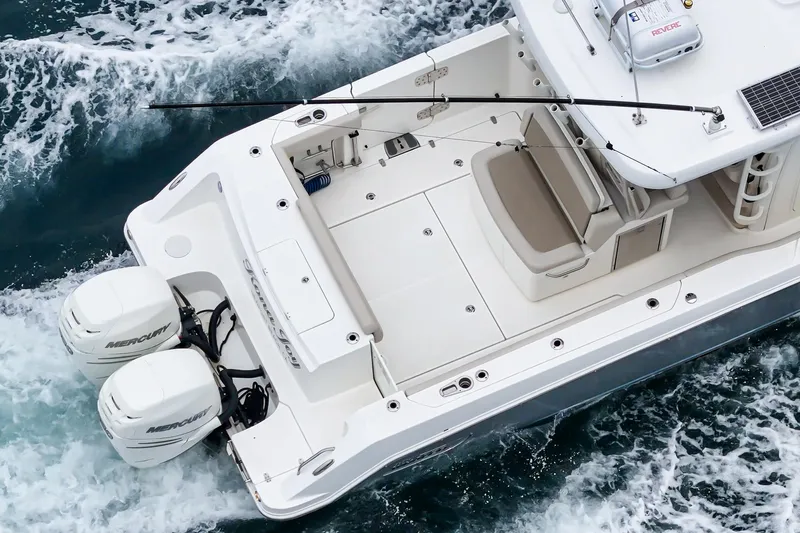  Yacht Photos Pics 2019 Boston Whaler 330 Outrage boat with dual engines cruising on water.