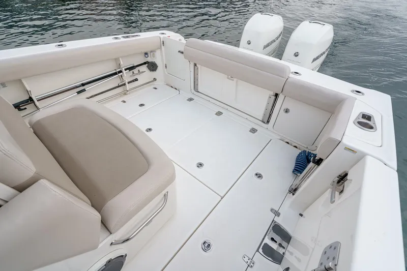  Yacht Photos Pics 2019 Boston Whaler 330 Outrage boat interior with seating and twin engines on water.