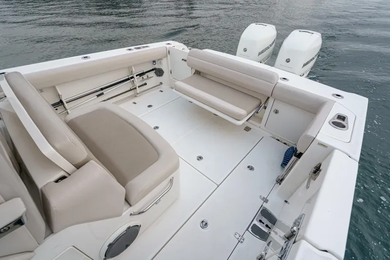  Yacht Photos Pics 2019 Boston Whaler 330 Outrage boat interior with seating and twin engines.