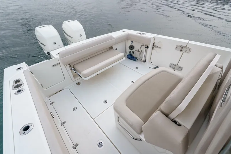  Yacht Photos Pics 2019 Boston Whaler 330 Outrage boat interior with seating and twin engines on water.